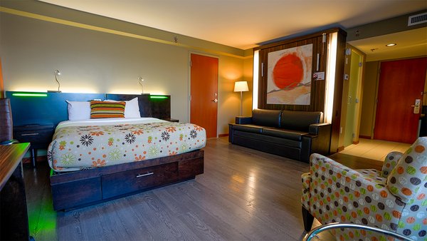 Trendy semi-adapted room with two large beds and a warm fireplace, offering comfort and accessibility to Hotel Must.