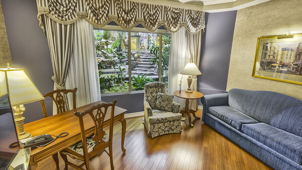 Suite adapted to the Palace Royal, consisting of two rooms with a double bed and a sofa bed, offering a partial view of the garden
