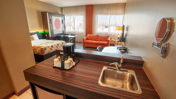 Studio Loft with two double beds, a sofa bed and a dining table, offering a modern and comfortable space at the Must Hotel.