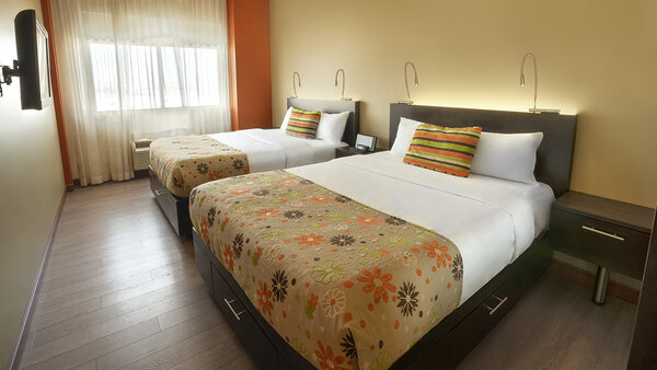 Large suite with three double beds, two separate rooms and a kitchenette, offering comfort and convenience at the Hotel Must.
