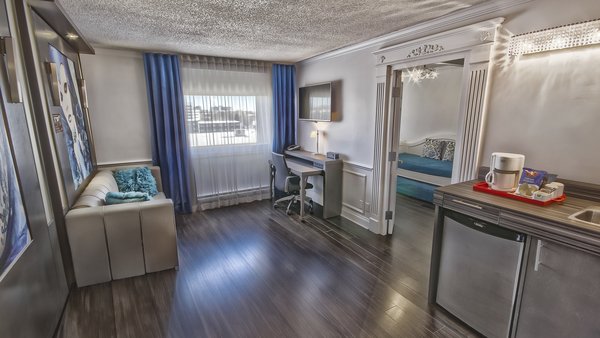 Family Privilege Room at the Hôtel Plaza Québec, a two-room suite with five beds and a multi-jet shower, featuring a bright, modern decor.