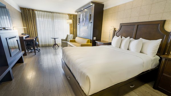 Spacious Comfort Room at Hôtel Québec, with two large beds and a fireplace, offering a warm, comfortable setting for a pleasant stay.