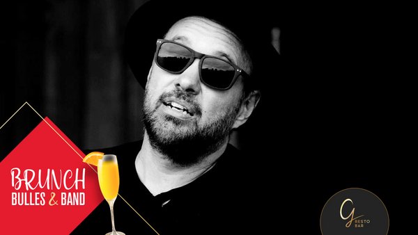 Jonathan Guérette, musical performer at the Plaza Hotel, wearing sunglasses and a hat, captured in a black-and-white portrait.